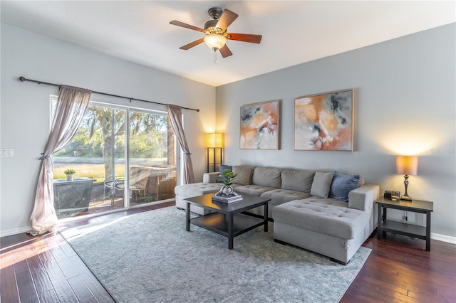 living room featuring ceiling fan and dark hardwood / wood-style flooring