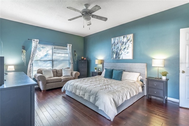 bedroom featuring dark hardwood / wood-style flooring, a textured ceiling, and ceiling fan