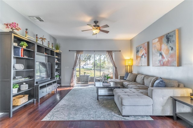 living room featuring ceiling fan and dark hardwood / wood-style flooring