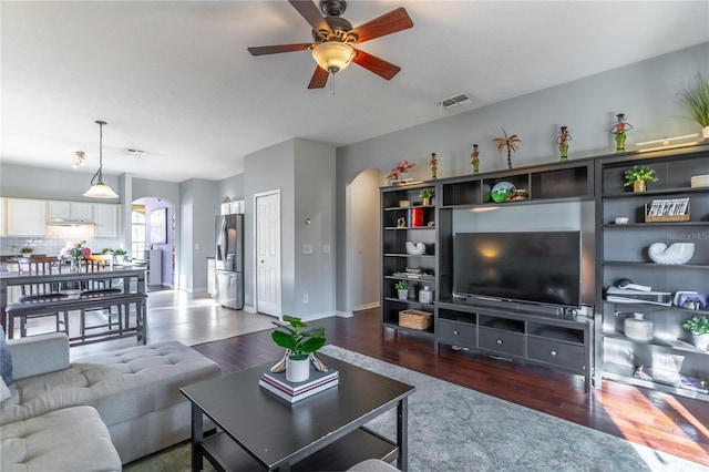 living room with dark hardwood / wood-style floors and ceiling fan