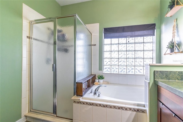 bathroom with vanity and independent shower and bath