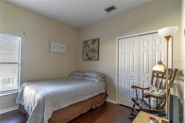 bedroom featuring dark hardwood / wood-style flooring and a closet