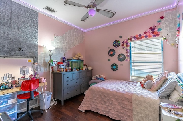 bedroom featuring ceiling fan, ornamental molding, and dark hardwood / wood-style flooring