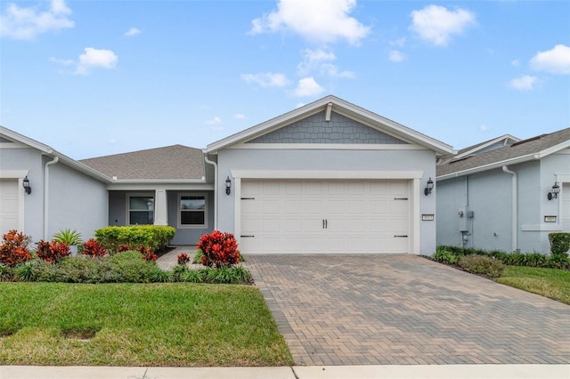 view of front of property featuring a garage and a front lawn