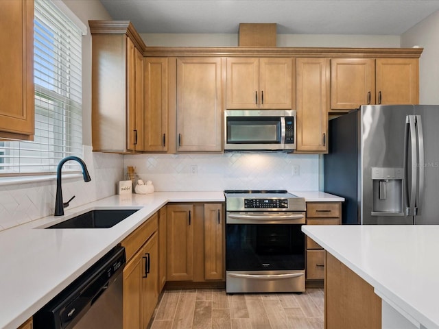 kitchen with tasteful backsplash, appliances with stainless steel finishes, and sink