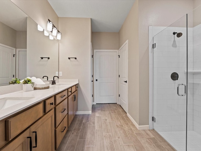 bathroom with a shower with door and vanity