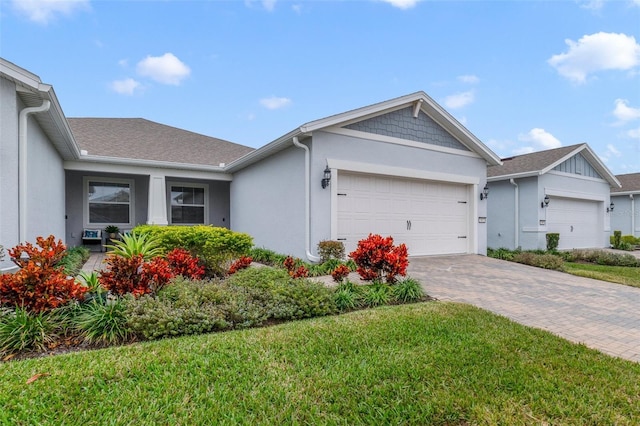 ranch-style house with a garage and a front lawn