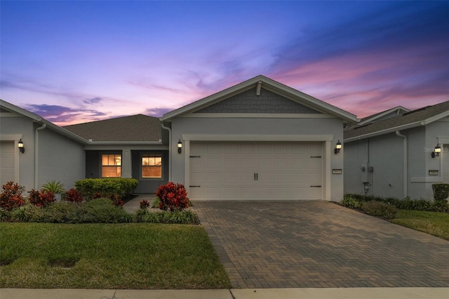 view of front of house with a garage and a lawn