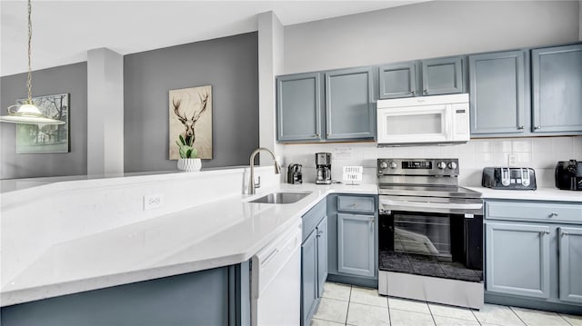 kitchen with pendant lighting, sink, decorative backsplash, light tile patterned floors, and white appliances