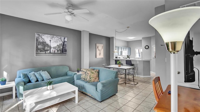 living room featuring light tile patterned flooring and ceiling fan