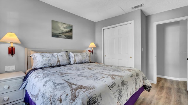 bedroom featuring hardwood / wood-style flooring and a closet