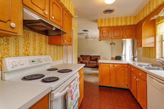 kitchen with ceiling fan, sink, white appliances, and kitchen peninsula