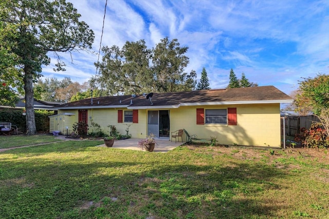 back of property featuring a lawn and a patio area