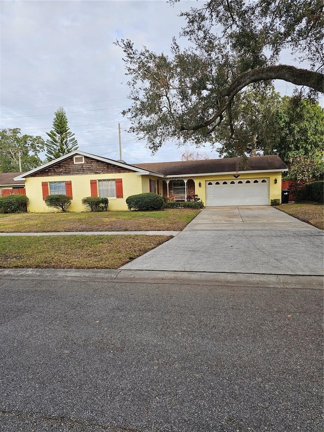 ranch-style house featuring a garage and a front yard