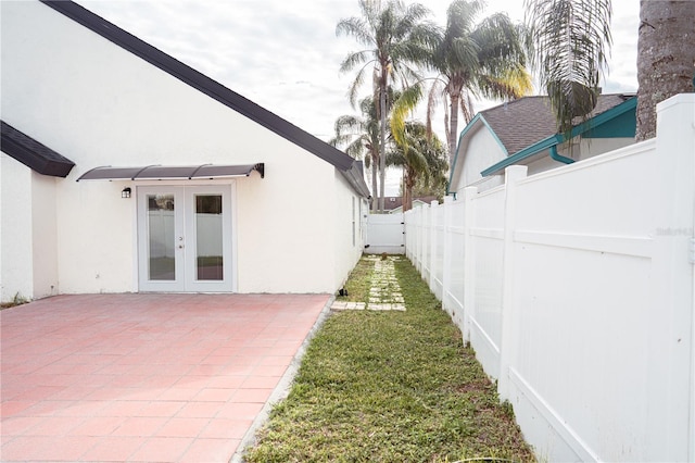 view of yard with french doors and a patio area