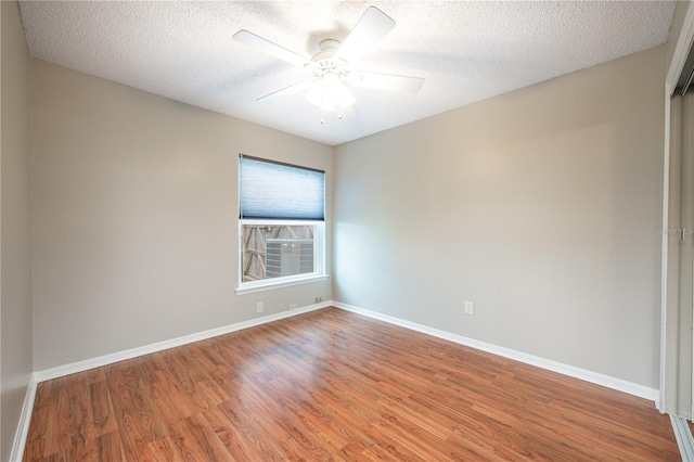 spare room featuring hardwood / wood-style flooring, a textured ceiling, and ceiling fan