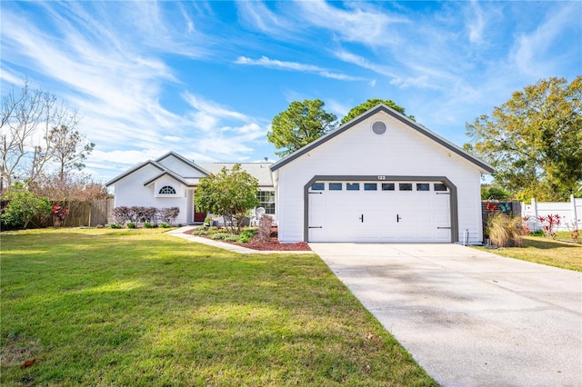 ranch-style house featuring a garage and a front lawn