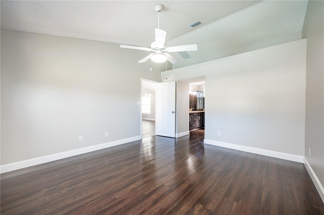 spare room with ceiling fan, lofted ceiling, and dark hardwood / wood-style flooring