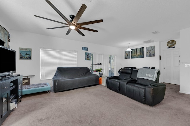 carpeted living room with ceiling fan