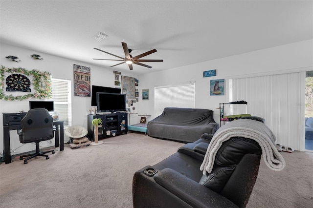 carpeted living room featuring ceiling fan