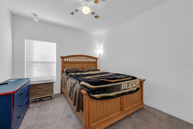 bedroom featuring light colored carpet and ceiling fan