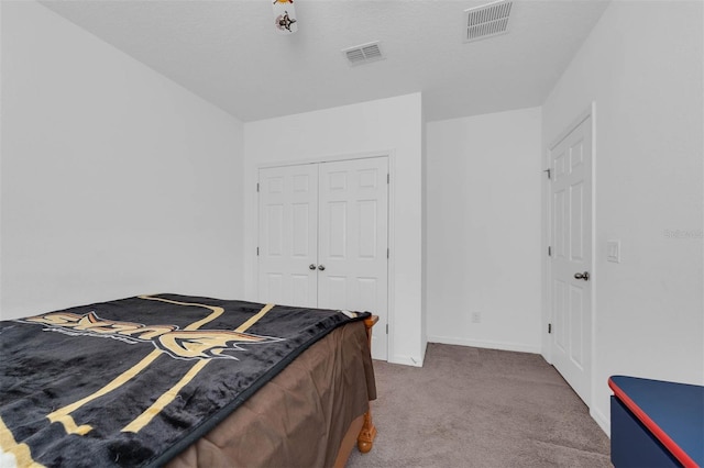 carpeted bedroom featuring a closet