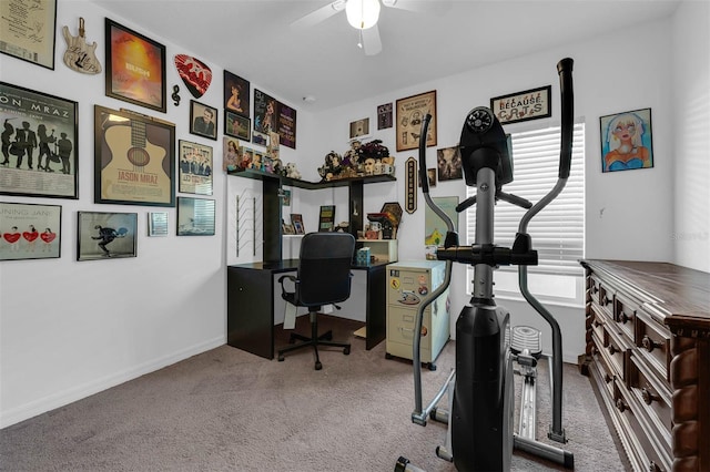 carpeted office featuring ceiling fan