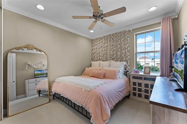 carpeted bedroom with ornamental molding and ceiling fan