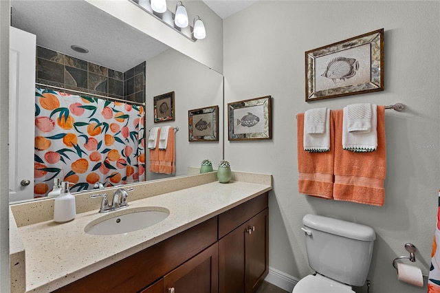 bathroom with vanity, curtained shower, and toilet