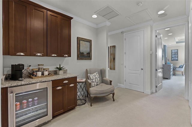 bar with wine cooler, light colored carpet, crown molding, and dark brown cabinets