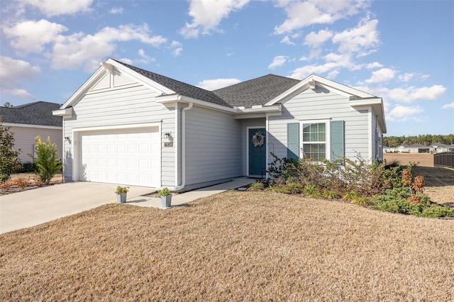 single story home with a garage and a front lawn