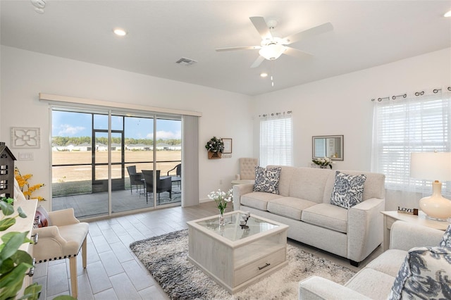 living room featuring ceiling fan and light wood-type flooring