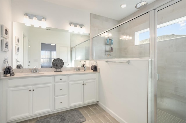 bathroom featuring vanity, plenty of natural light, and walk in shower