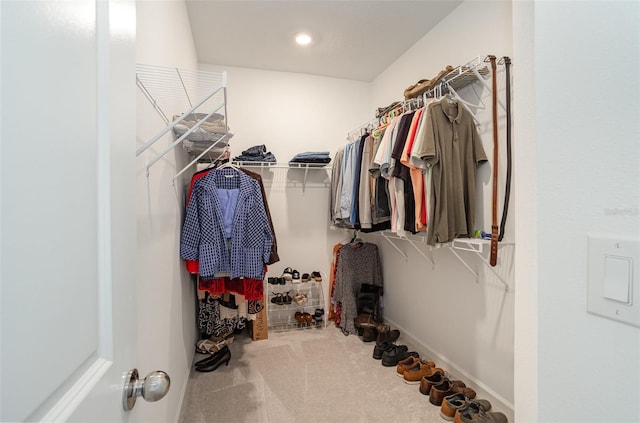 walk in closet with carpet