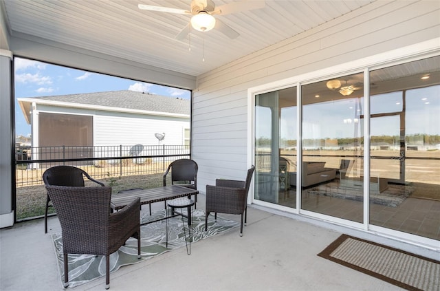 sunroom featuring ceiling fan