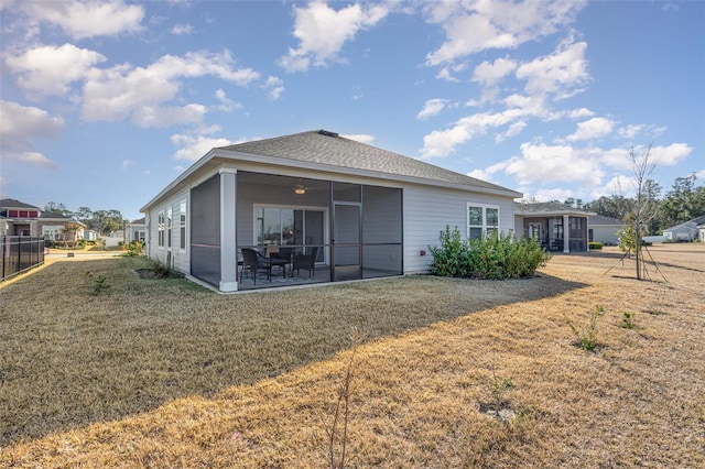 back of property featuring a patio, a sunroom, and a lawn