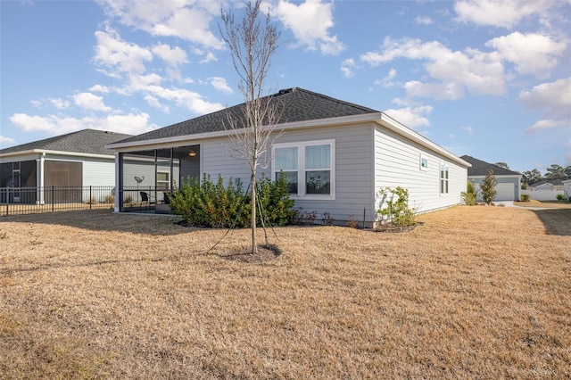 rear view of house with a yard