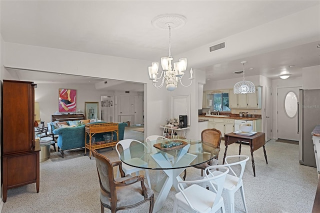 dining room with sink and a notable chandelier