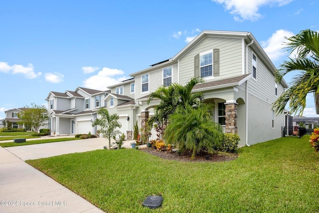 view of front of house featuring a garage and a front lawn