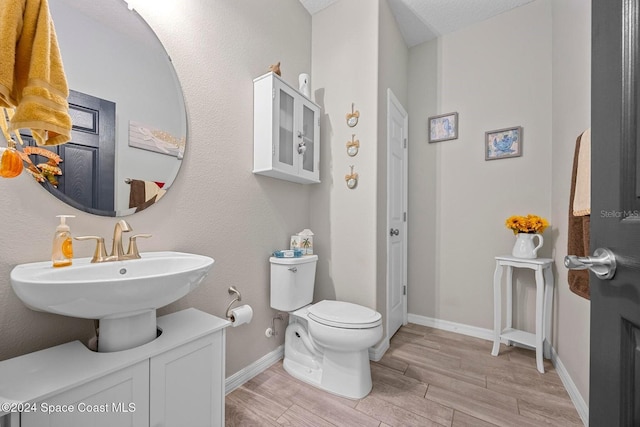 bathroom featuring a textured ceiling and toilet