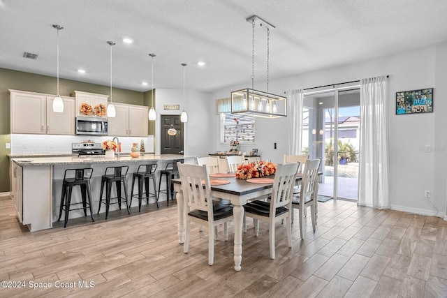 dining area featuring sink and a textured ceiling