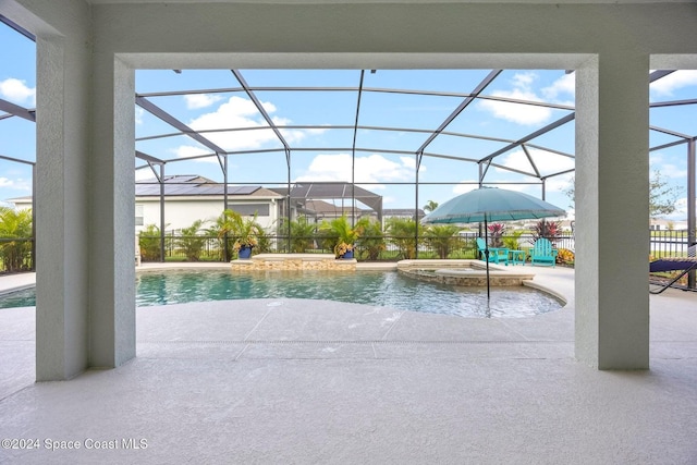 view of swimming pool featuring an in ground hot tub, pool water feature, a lanai, and a patio area