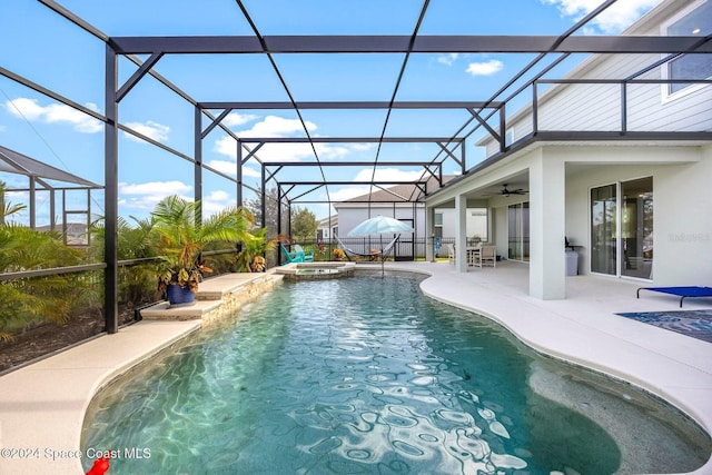 view of swimming pool featuring an in ground hot tub, ceiling fan, glass enclosure, and a patio