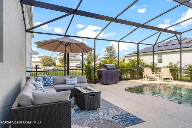 view of patio featuring a lanai, a grill, and an outdoor living space with a fire pit