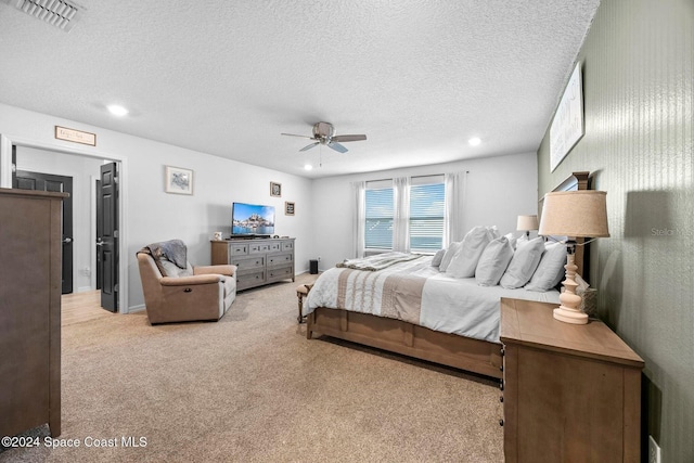 carpeted bedroom with a textured ceiling and ceiling fan