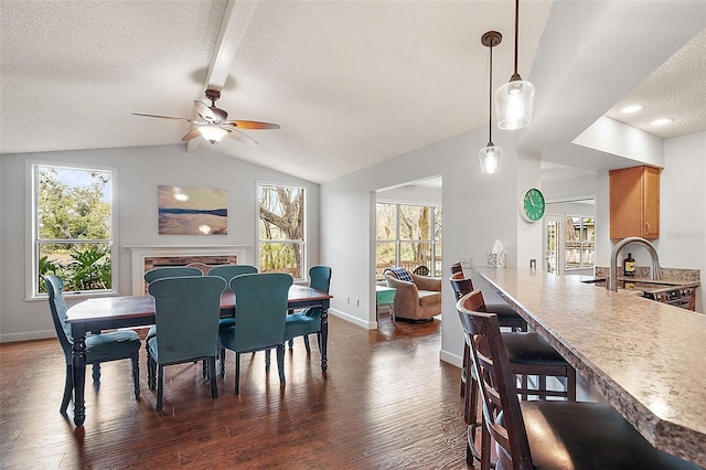 dining area with dark wood-type flooring, lofted ceiling, sink, a textured ceiling, and ceiling fan