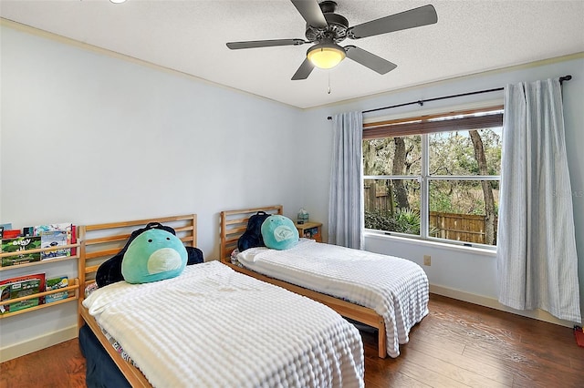 bedroom with dark wood-type flooring and ceiling fan