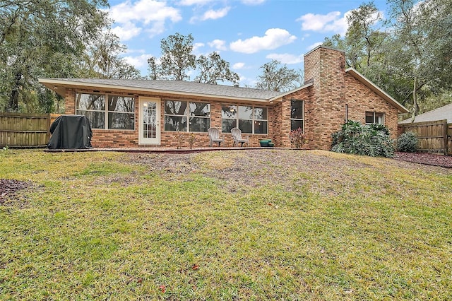 rear view of property with a yard