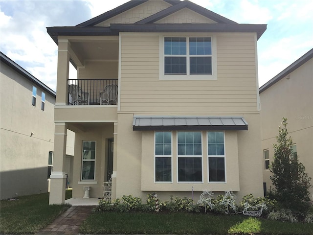 back of house with a balcony