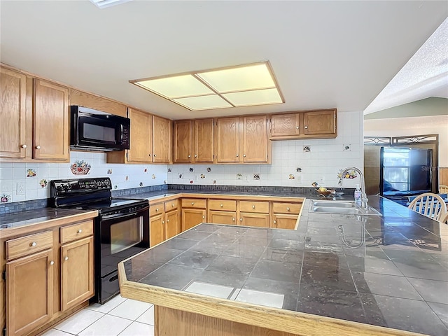 kitchen with backsplash, kitchen peninsula, sink, and black appliances